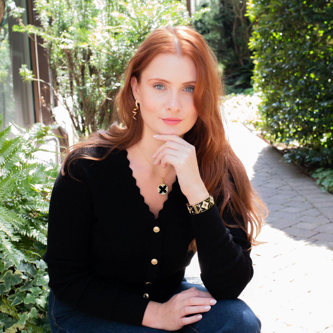 Woman wearing gold and black jewelry