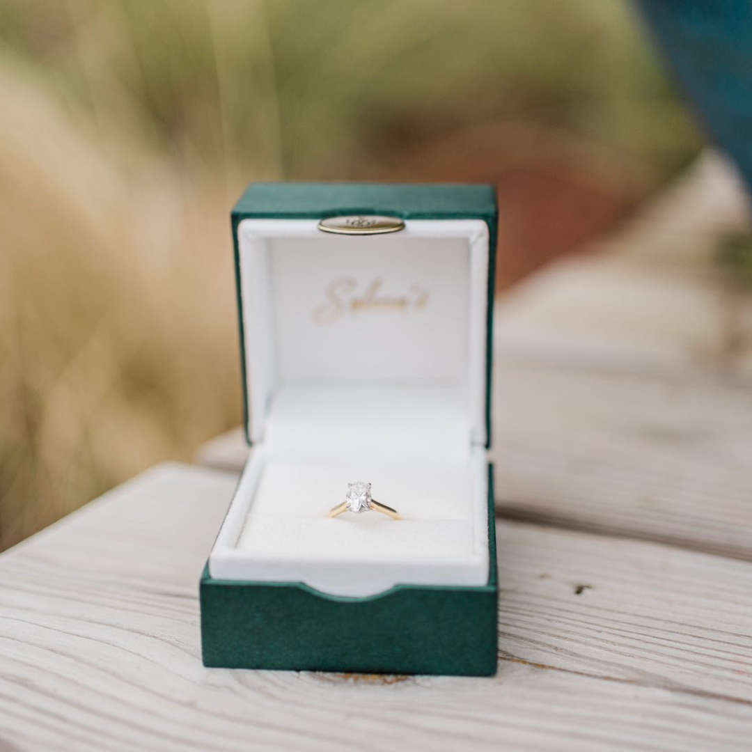 an open Sylvan's Jewelers box with an engagement ring inside