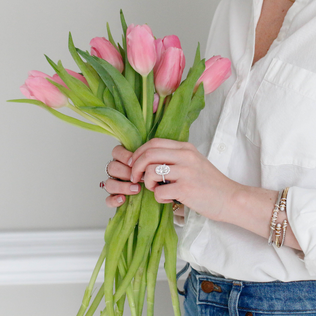 Woman wearing jewelry holding flowers